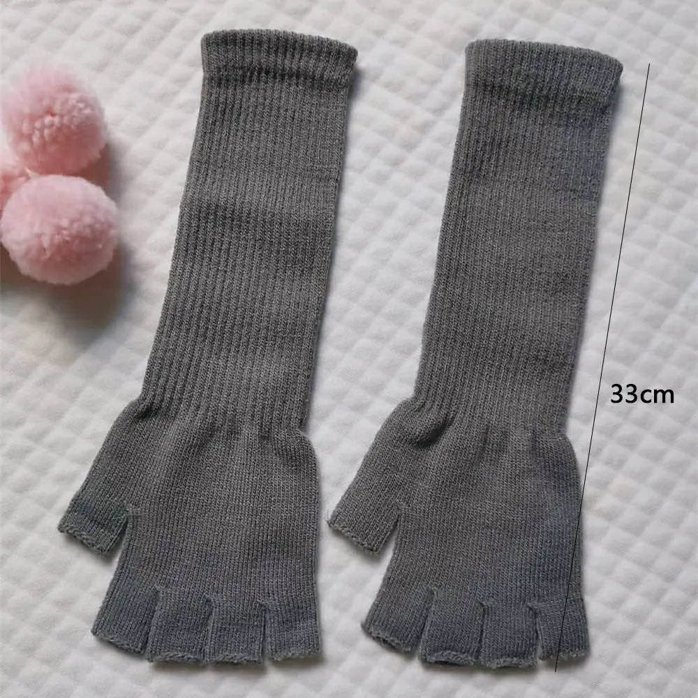 Grey long fingerless gloves laid flat, 33 cm long
