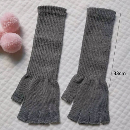 Grey long fingerless gloves laid flat, 33 cm long