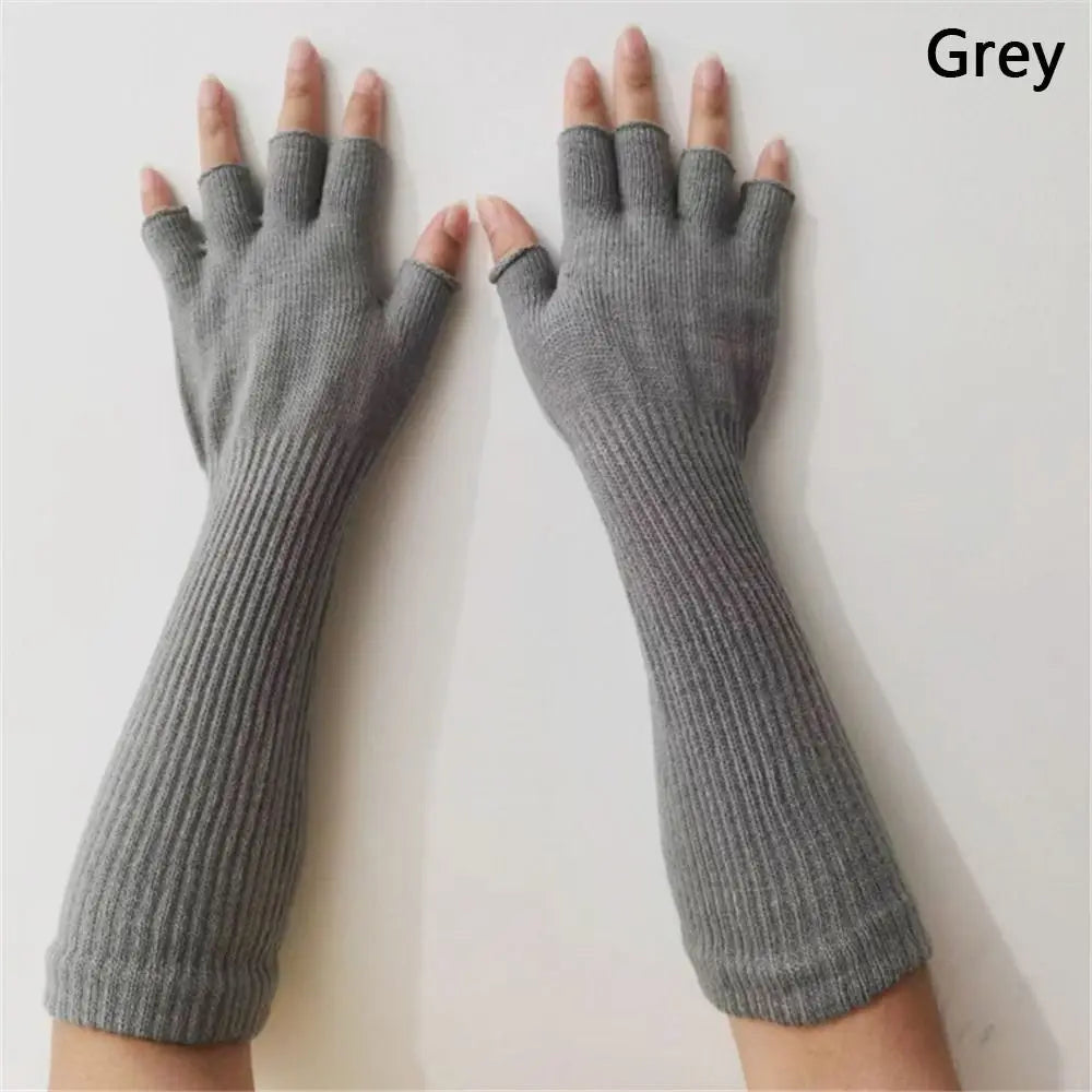 Long fingerless gloves in grey, worn on both hands