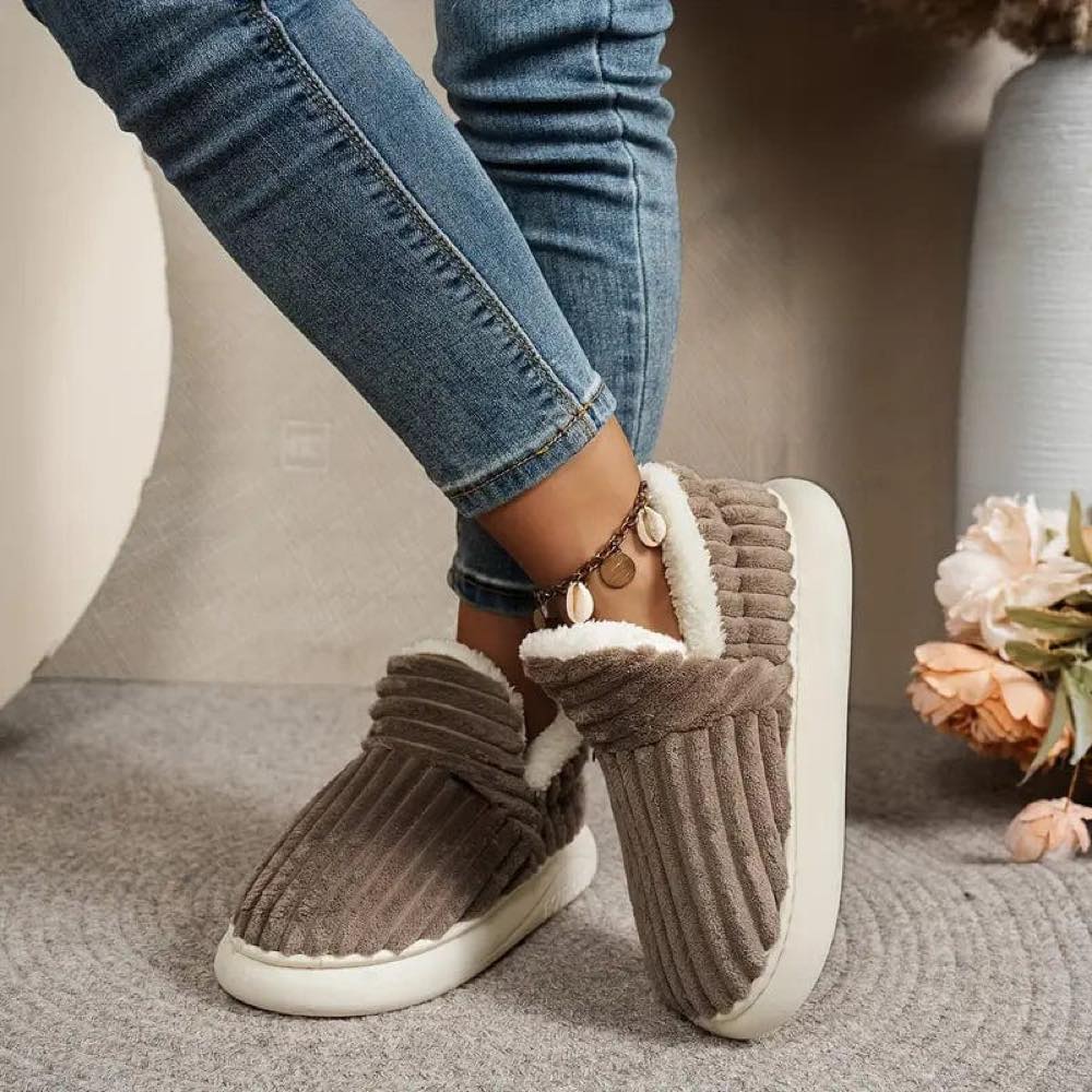 Brown WarmStep winter slippers worn indoors