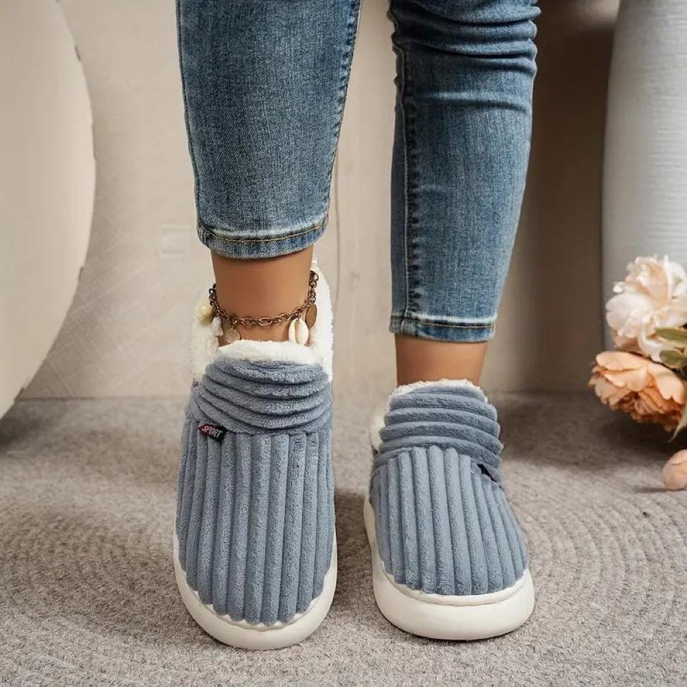 Grey WarmStep winter slippers worn indoors