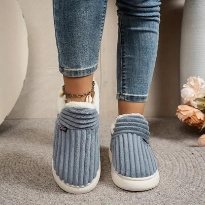 Grey WarmStep winter slippers worn indoors