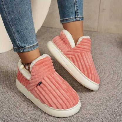 Pink WarmStep winter slippers worn indoors